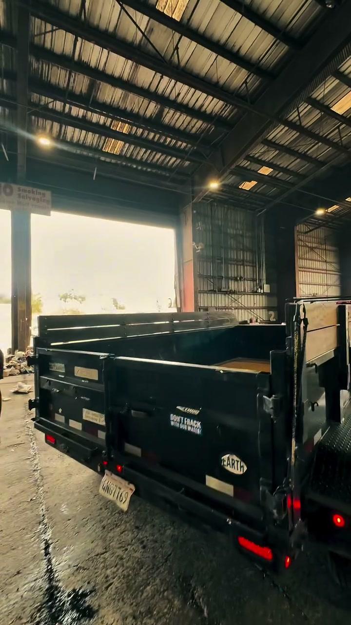 The black bin trailer from the rear, empty